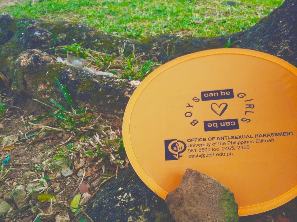 "Boys can be girls," surrounding a drawing of a heart. Written on a fan with OASH's contact details.